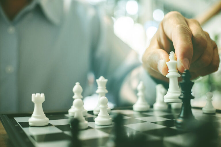 businessman playing chess board, Competition in business.